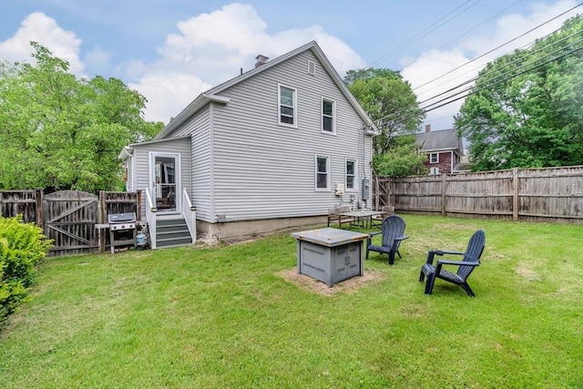 15 Ryan Rd, Northampton, MA 01062 - back of house featuring a fire pit, a gate, and a chimney