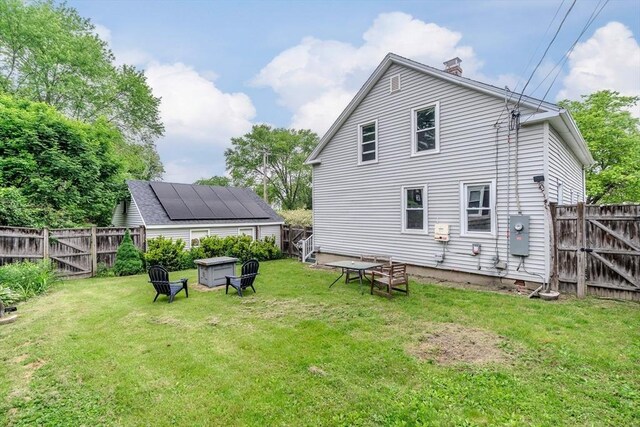15 Ryan Rd, Northampton, MA 01062 - back of property with a chimney and a gate