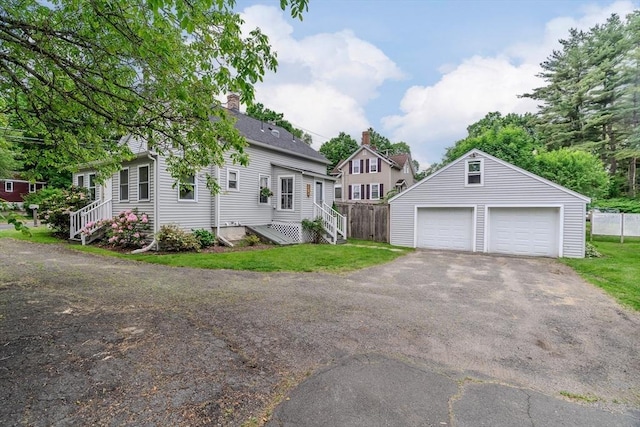 15 Ryan Rd, Northampton, MA 01062 - view of front of house with a garage, an outbuilding, and a chimney