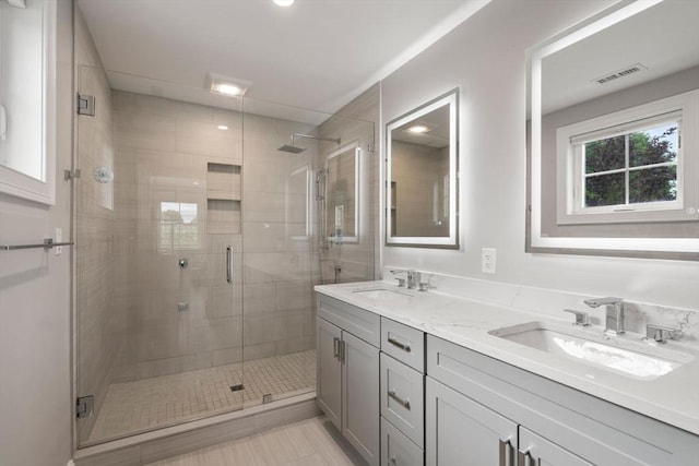 94 Webster Unit 94, Newton, MA 02465 - bathroom with double vanity, a stall shower, recessed lighting, and tile patterned flooring
