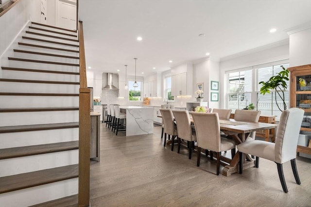 94 Webster Unit 94, Newton, MA 02465 - dining space with light wood finished floors, stairs, crown molding, and recessed lighting