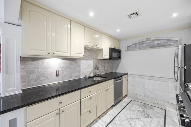 kitchen featuring dishwasher, sink, crown molding, dark stone countertops, and cream cabinetry