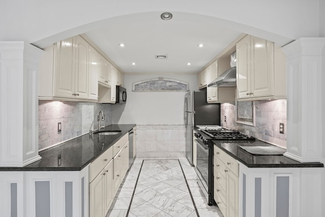 kitchen featuring white cabinets, sink, stainless steel appliances, and tasteful backsplash