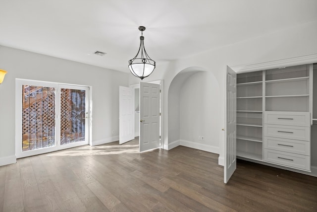 unfurnished living room featuring dark hardwood / wood-style flooring