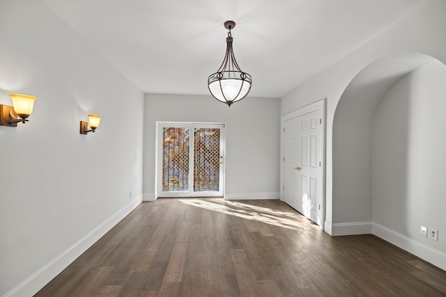 unfurnished dining area featuring dark hardwood / wood-style floors