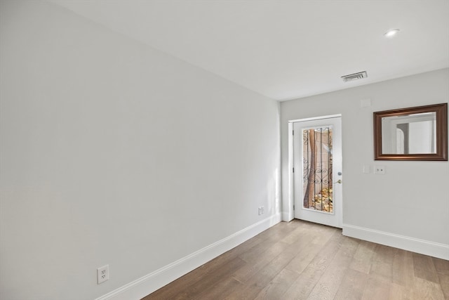 spare room with light wood-type flooring