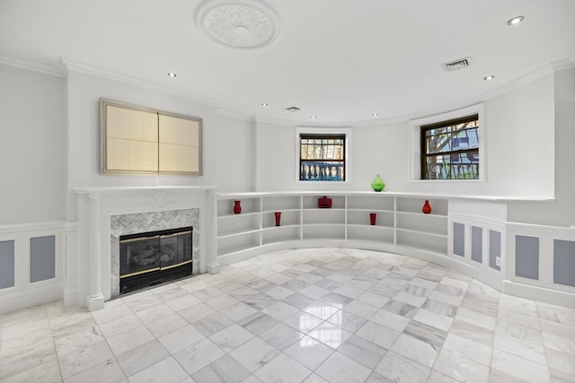 unfurnished living room with a tile fireplace and crown molding