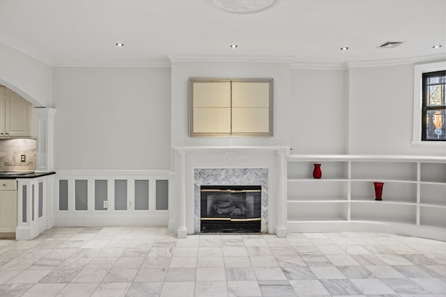 unfurnished living room with ornamental molding and a fireplace