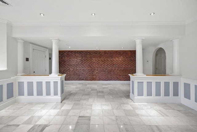 corridor with crown molding and brick wall