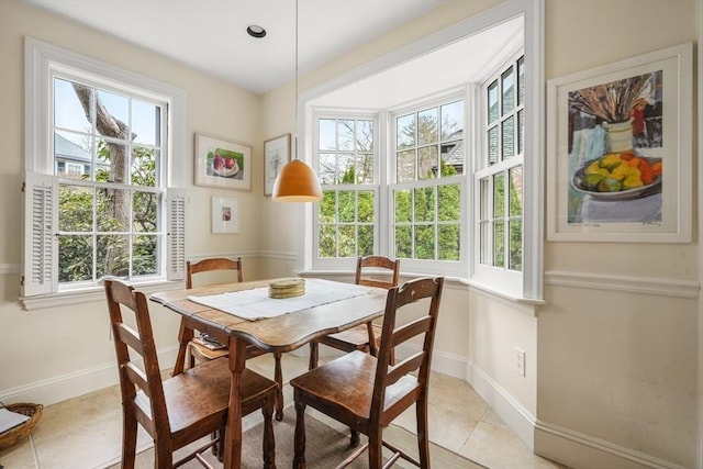 dining space with plenty of natural light and light tile patterned floors
