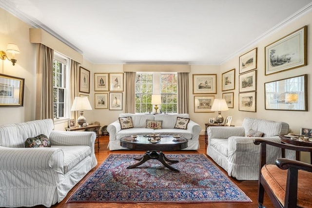 living area with plenty of natural light, wood finished floors, and ornamental molding