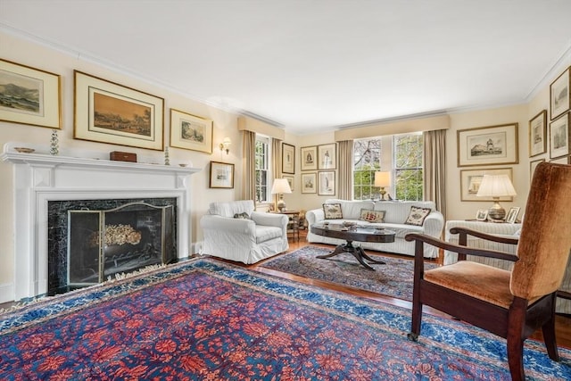 living room featuring ornamental molding, a high end fireplace, and wood finished floors