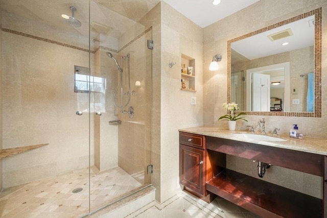 full bathroom featuring a shower stall and vanity