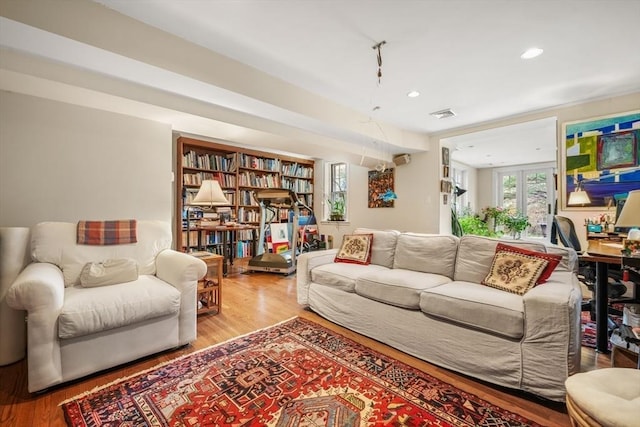 living area featuring wood finished floors and recessed lighting