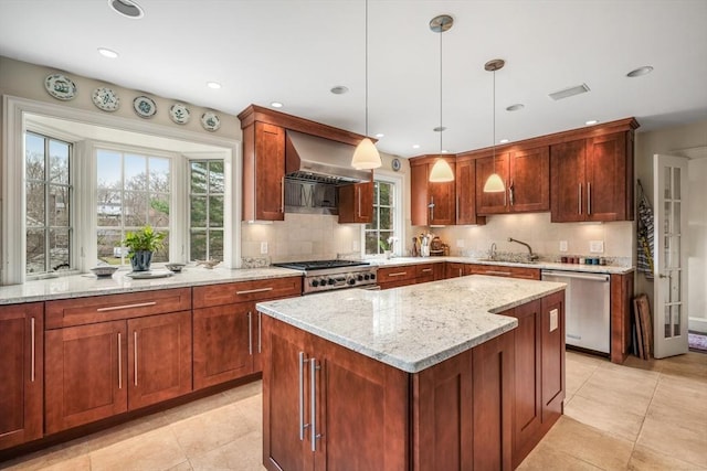 kitchen with dishwasher, wall chimney exhaust hood, tasteful backsplash, light stone countertops, and a sink