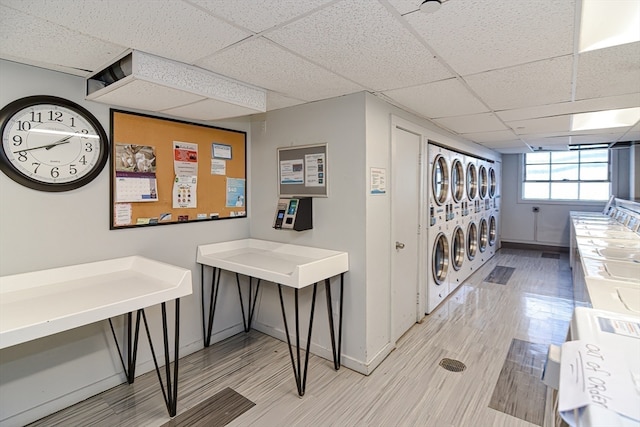 interior space with washer and clothes dryer, stacked washing maching and dryer, and hardwood / wood-style floors