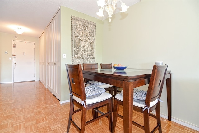 dining space with a notable chandelier and light parquet floors