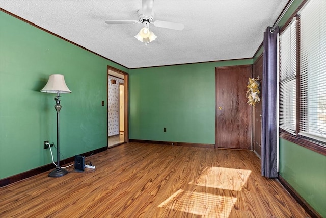 interior space featuring a textured ceiling, ceiling fan, and light hardwood / wood-style flooring