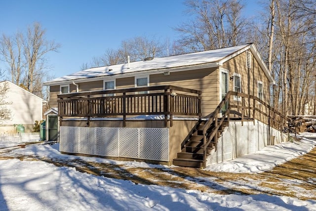 snow covered property featuring a wooden deck