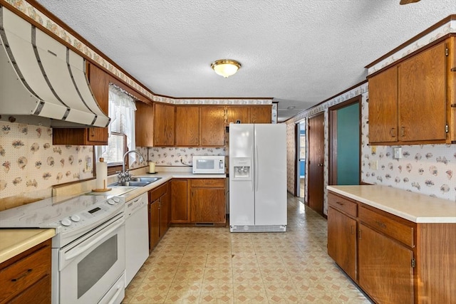 kitchen featuring sink, a textured ceiling, white appliances, and range hood