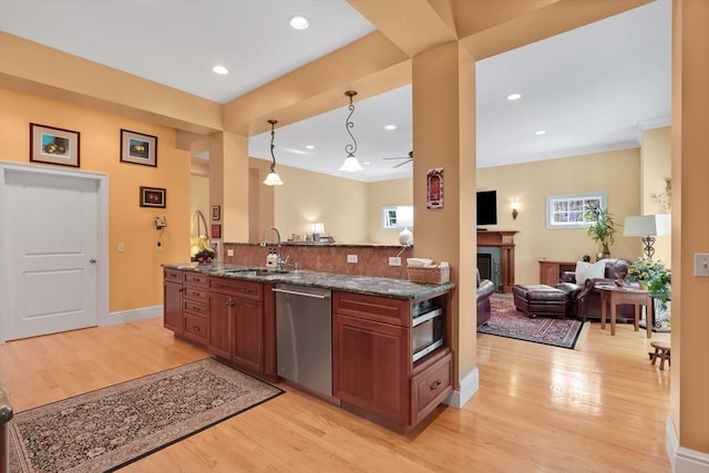 kitchen featuring open floor plan, light wood-style flooring, plenty of natural light, and stainless steel appliances