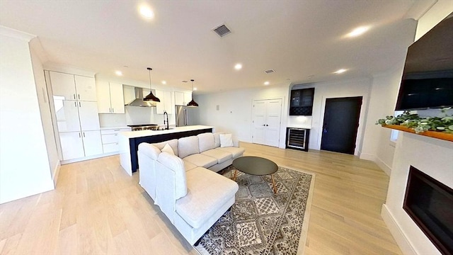 148 W 9th St Unit 6, Boston, MA 02127 - living area featuring beverage cooler, recessed lighting, light wood-style floors, and a fireplace