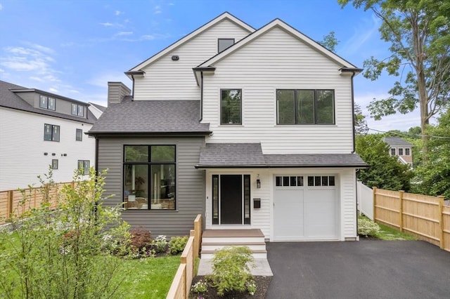 7 Johnson Pl Unit 7, Newton, MA 02466 - view of front facade with a shingled roof, asphalt driveway, and an attached garage