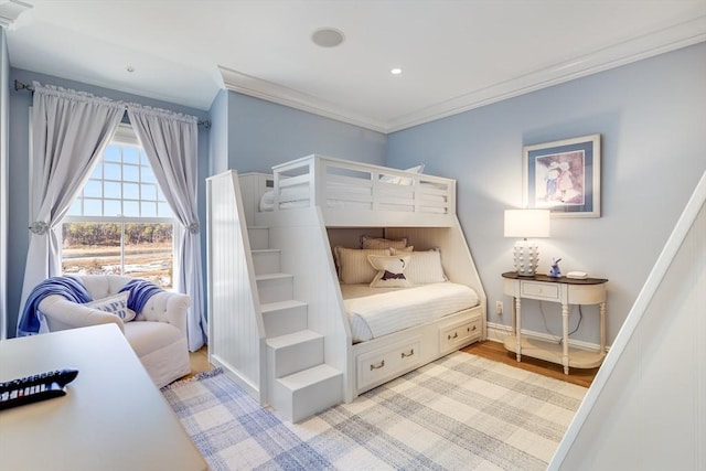 bedroom with crown molding and light hardwood / wood-style flooring