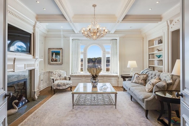 living room featuring hardwood / wood-style flooring, a premium fireplace, beam ceiling, coffered ceiling, and built in shelves