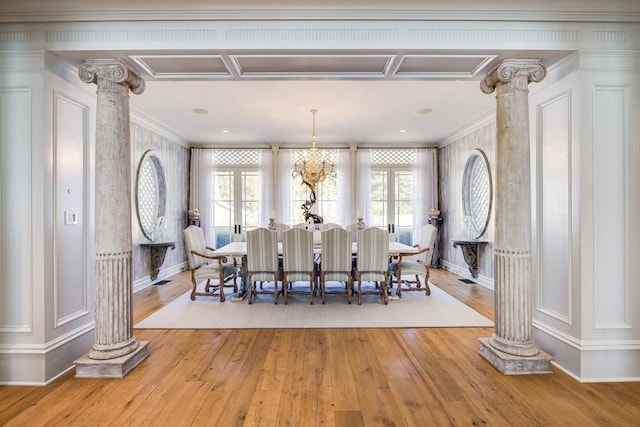 dining room with ornamental molding, decorative columns, and light hardwood / wood-style flooring