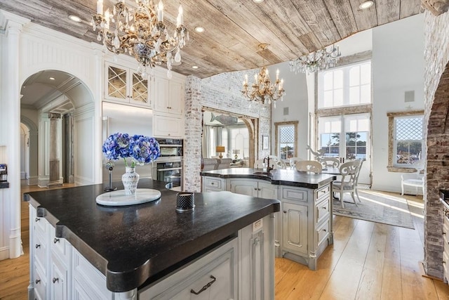 kitchen with white cabinetry, wood ceiling, and a center island