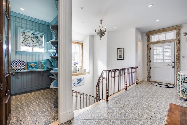 entryway with a chandelier