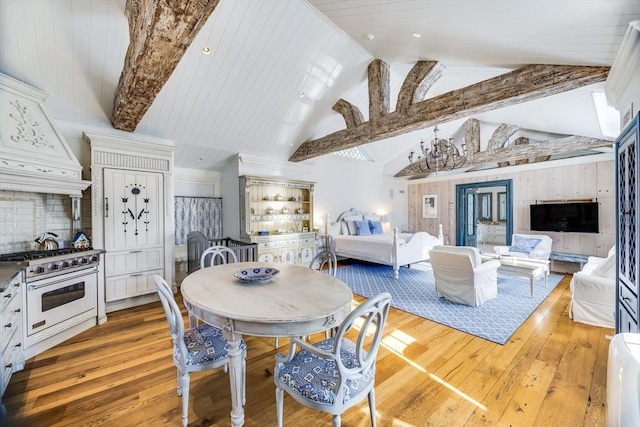 dining room featuring lofted ceiling with beams, wooden ceiling, a notable chandelier, and light hardwood / wood-style flooring