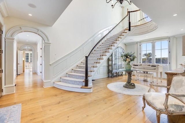 entrance foyer featuring ornamental molding and light hardwood / wood-style flooring