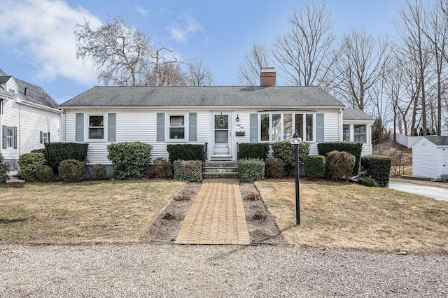 single story home featuring a shingled roof, a front lawn, and a chimney