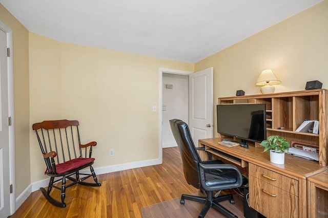 office space with wood finished floors and baseboards