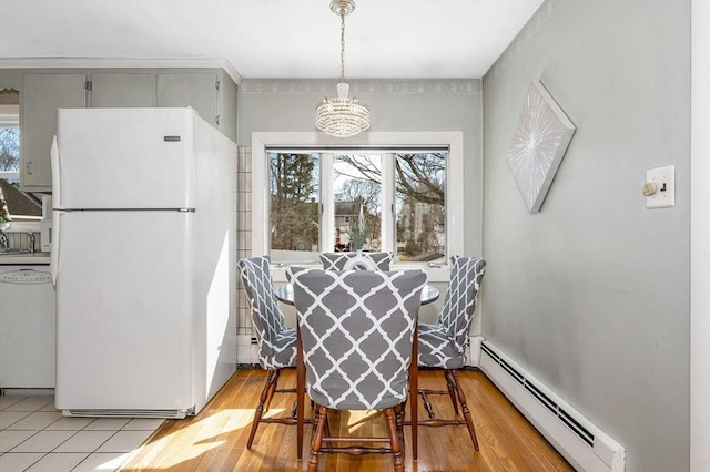 dining room with light wood-type flooring and baseboard heating