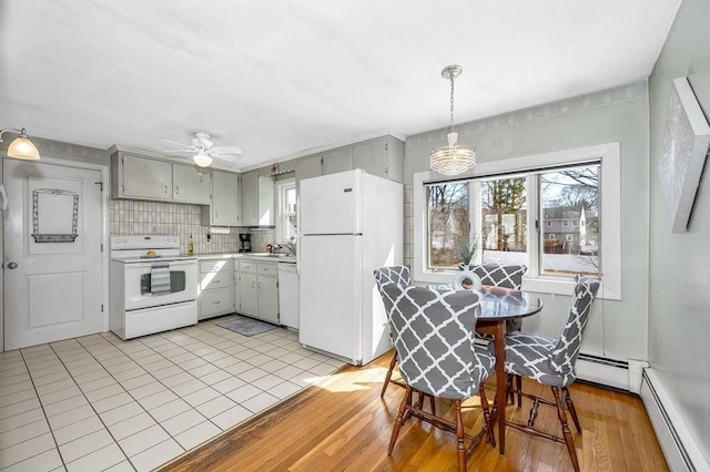 kitchen featuring light wood finished floors, a baseboard heating unit, white appliances, and light countertops