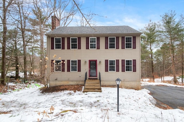 colonial-style house with a chimney