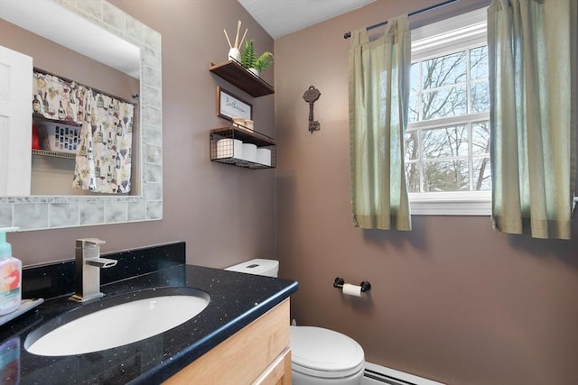 bathroom with a baseboard radiator, vanity, and toilet