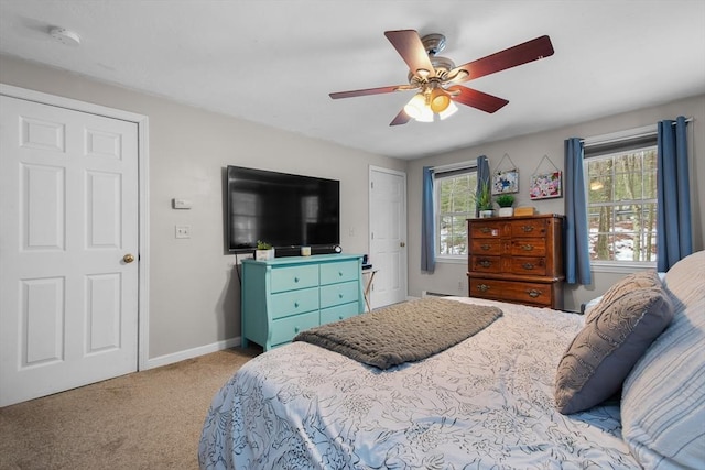 carpeted bedroom featuring ceiling fan and baseboards