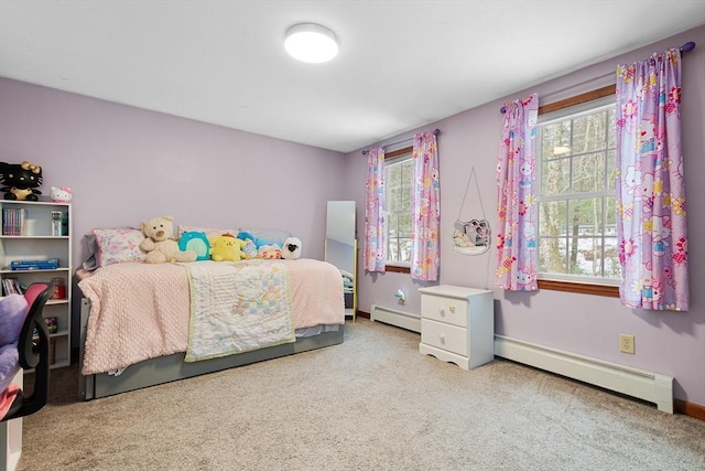 bedroom featuring a baseboard radiator and multiple windows