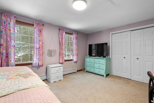 bedroom featuring a closet, baseboards, carpet flooring, and baseboard heating