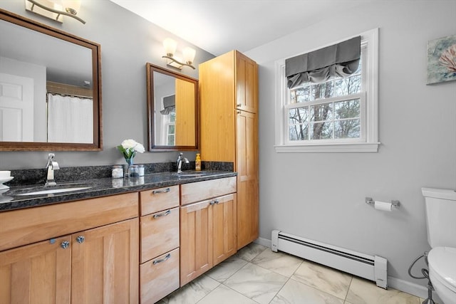 full bath featuring toilet, a sink, marble finish floor, baseboard heating, and double vanity