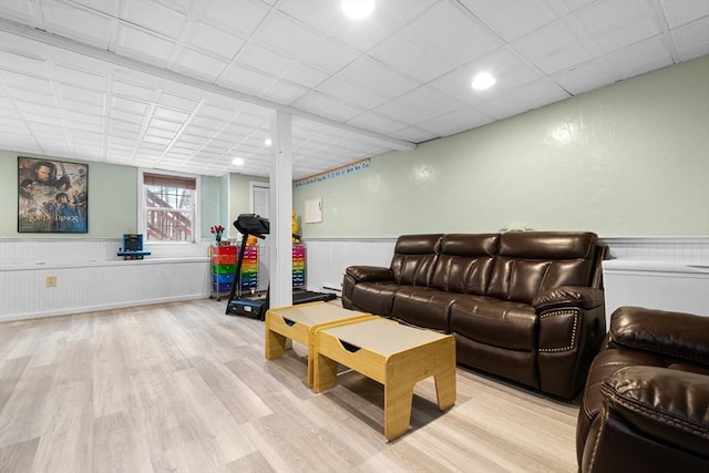 living room featuring light wood-type flooring and wainscoting