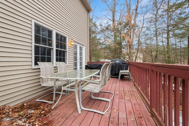 wooden deck with outdoor dining area and french doors