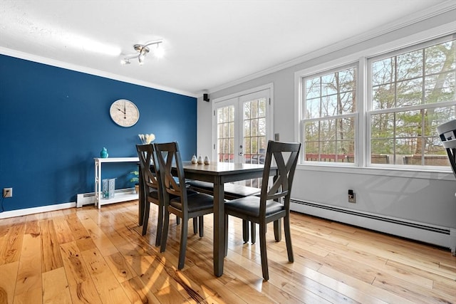 dining room featuring a baseboard radiator, ornamental molding, french doors, baseboard heating, and hardwood / wood-style floors