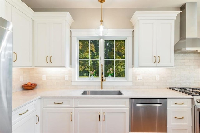 kitchen with wall chimney exhaust hood, sink, and white cabinetry