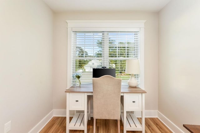 office with light hardwood / wood-style flooring