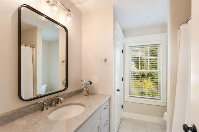 bathroom featuring toilet, tile patterned floors, and vanity